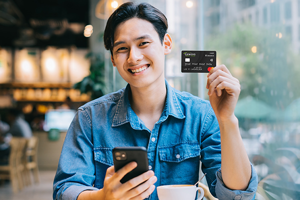Young man with credit card in restaurant 